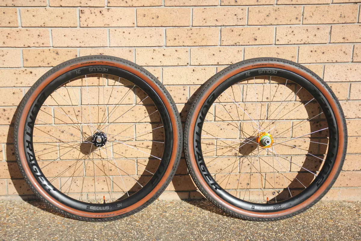 The finished front and rear wheels side by side against a brick wall