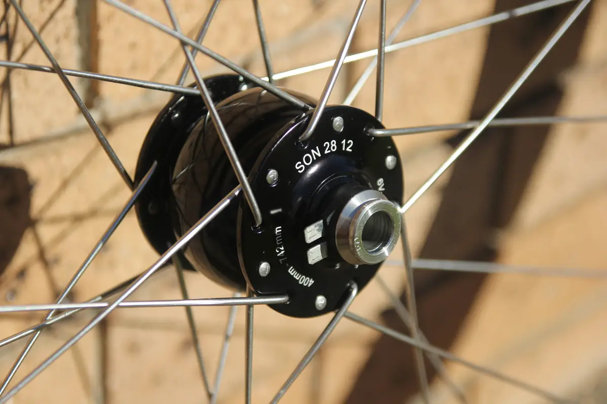 Close-up of the SON 28 dynamo front hub and its spoke flange