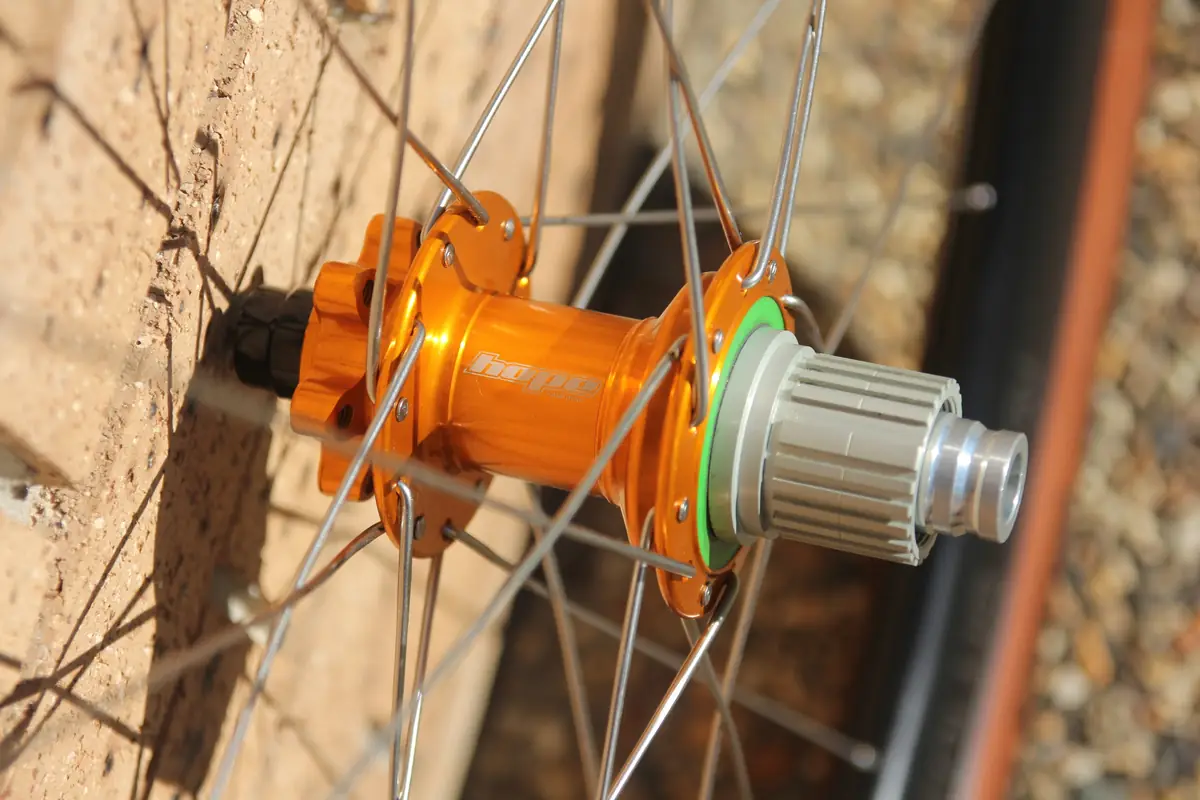 Close-up of the orange Hope rear hub and freehub body