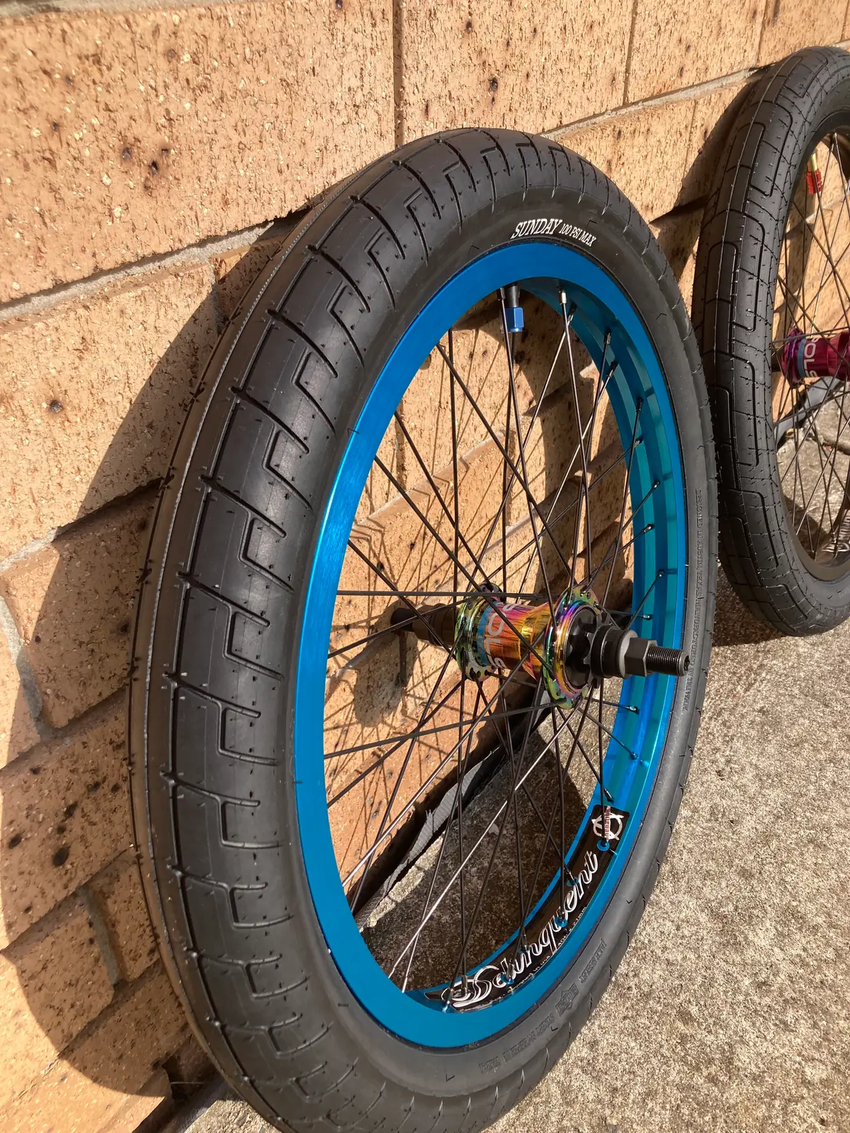 A finished 20-inch rear wheel with a blue rim and black tyre