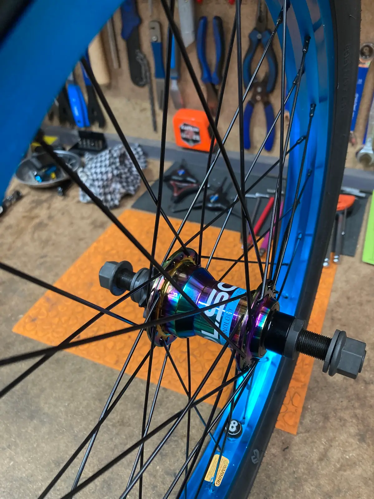 An oil-slick hub being trued in the workshop stand