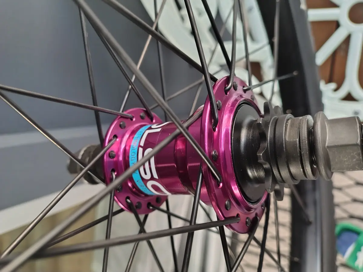 Close-up of the pink anodised hub shell and axle