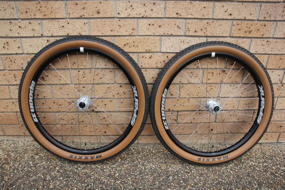 The finished front and rear wheels side by side against a brick wall