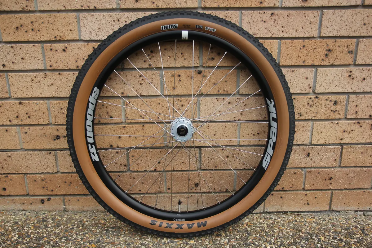 A finished wheel side-on, showing the Spank rim and tan-wall Maxxis tyre