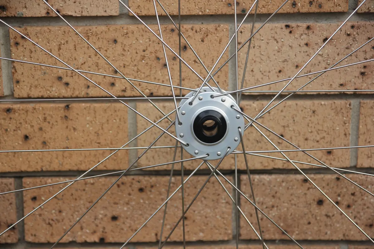 The front hub shot head-on through the spokes, showing the lacing pattern