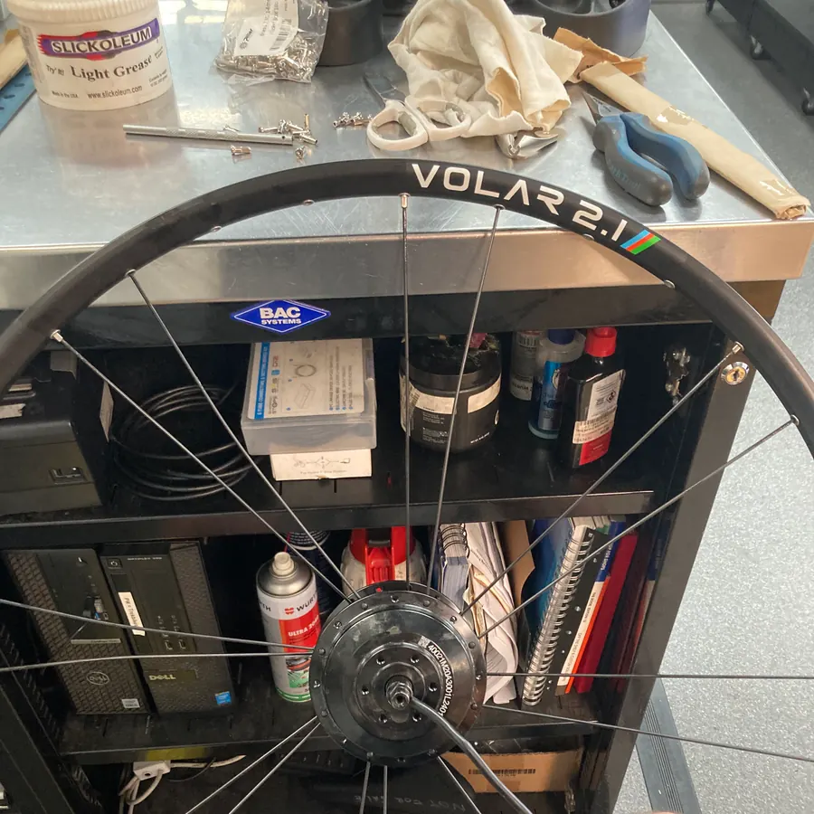 An eBike wheel being trued in the stand during a rebuild